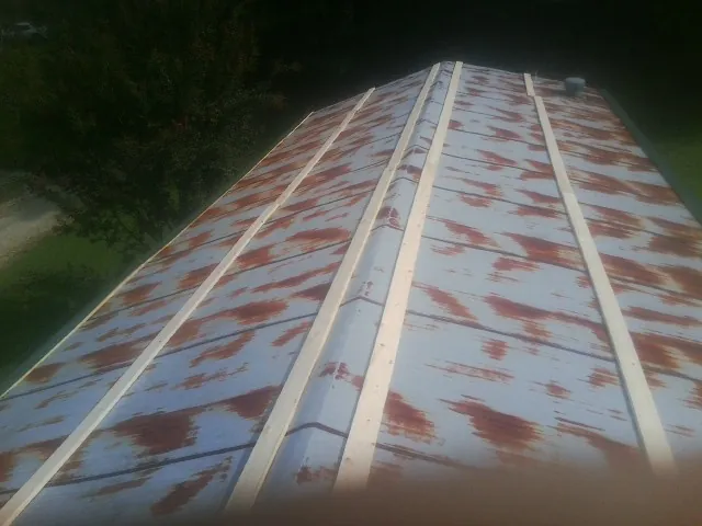 Rusted metal roof panels with new wood purlins before replacement — Storm Damage Roof Repair in Mckinney by Roofing Brothers